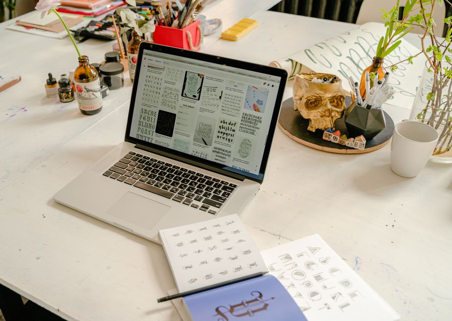 A design studio desk with type specimens and printed proofs.