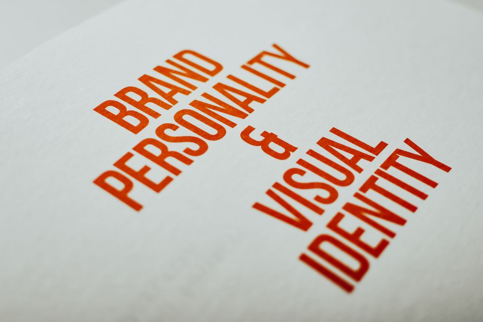An open brand guidelines book showing logo usage rules.